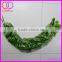 artificial green leaves outside wall covering