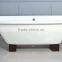 rectangular freestanding cast iron bathtub with wooden cradle