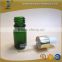 green essential oil glass bottle with silver glass pipette