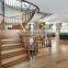arc curved stairs with metal railing and thick wood stair tread