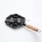 Mini cast iron takoyaki grill with wooden handle