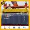 Rotating container lifting spreader