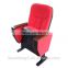 Great orange fabric auditorium chair with writing pad on the right side