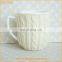 Ceramic coffee mug with knitted sleeve cover