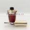 Red painted nail polish bottle with UV cap and shoulders