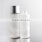 round glass lotion bottle with silver cap