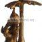brass ganesha under tree