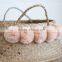 Blush color pompom Vietnam folding seagrass basket, natural color
