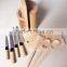 wooden knife block with three wooden utensils, four knives and 1chopping board
