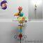 Shining metal bird standing on stick with metal garden decorative windmill
