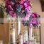 Centerpiece flower arrangement with white orchids cascading over the side, dripping crystal beads and roses
