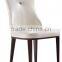 Concaved headrest dinning chair with white glossy PU covering and iron legs