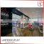 Modern hot sale retail wooden floor cosmetics display stand pink makeup display table