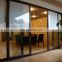 Three track safety glass aluminum sliding doors with mesh screen