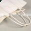 Twisted rope scarf paper packaging bags with custom 100% recycable paper white craft paper bags for kids shoes
