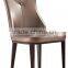 Concaved headrest dinning chair with white glossy PU covering and iron legs