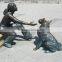 bronze girl with dog playing sculpture