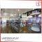Modern hot sale retail wooden floor cosmetics display stand pink makeup display table