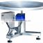 Adjustable rotation speed rotary table for collecting packaged food