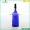 blue essential oil glass bottle with silver dropper