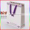 high quality white paper gift bag with purple ribbon