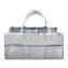 Grey diaper caddy with shoulder belt trim top edge and pocket edge cotton lining