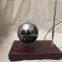 Rectangle red wooden base floating globe with a pen