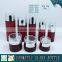 Red coloured cosmetic glass pump bottles and glass cream jars