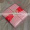 Hot sale luxurious pink silk hardcover wedding invitations with red ribbons&rhinestone brooches