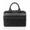 Black messenger bag with handle and front pocket