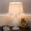 wholesale high end chrome round base glass table lamp with polished surface and barrel linen shade