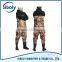 cheap pvc chest high fishing waders being used as waterproof workwear
