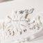 Pure white embossed wedding invitations for wedding with floral laser cut border & white ribbons