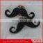 black epoxy with silver base mustache-shaped metal brooch