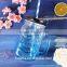 Hot selling products of glass drink pump lid 480ml colorful glass mason jar with handles wholesale