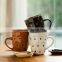White ceramic coffee mug with dot