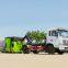 Hook arm garbage truck