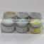 Multi-colored scented candle candle in tin box