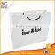Custom White paper gift bags with die cut ribbon handles