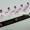 Pink polyester ribbon with crystal modification care label