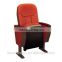 Great orange fabric auditorium chair with writing pad on the right side