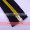 Zipper puller with golden elements