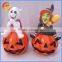 Ceramic pumpkins with halloween witch figurines