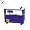 Manual box lumber strapping machine