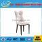 Concaved headrest dinning chair with white glossy PU covering and iron legs