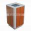 Metal and wooden outdoor trash bin