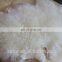Tanned raw white curly lamb fur