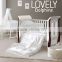 OEM Modern White Lacquer MDF Baby Cot Bed With Wheels