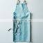 Custom blue cotton canvas kitchen apron with cross-back straps