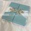 2016 hot sale high-auality elegant blue silk box wedding invitations with white ribbons and rhinestone brooches                        
                                                Quality Choice
